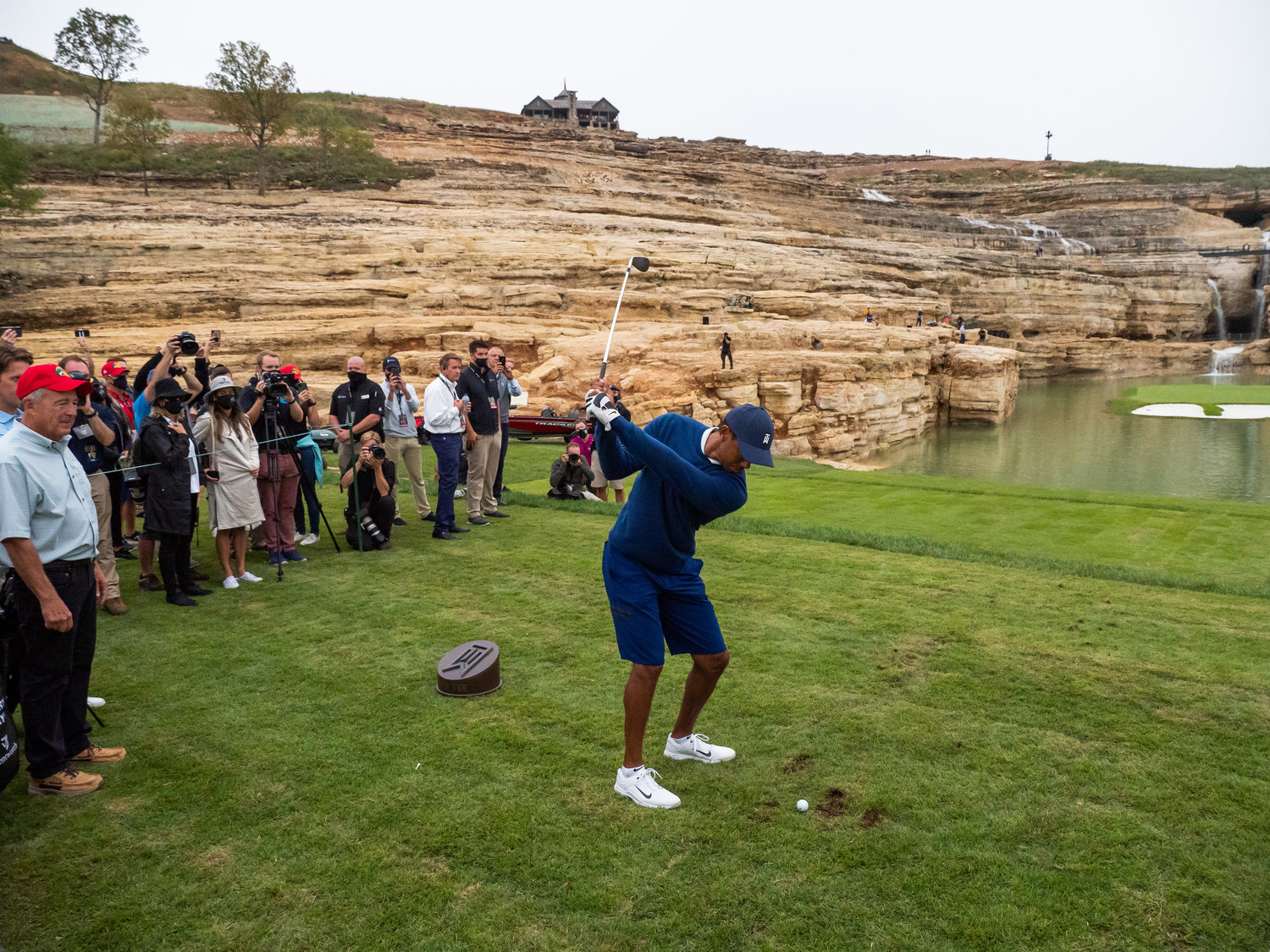 Big Cedar Lodge and Bass Pro Shops founder Johnny Morris, at left, watches Tiger Woods take aim at the new course.